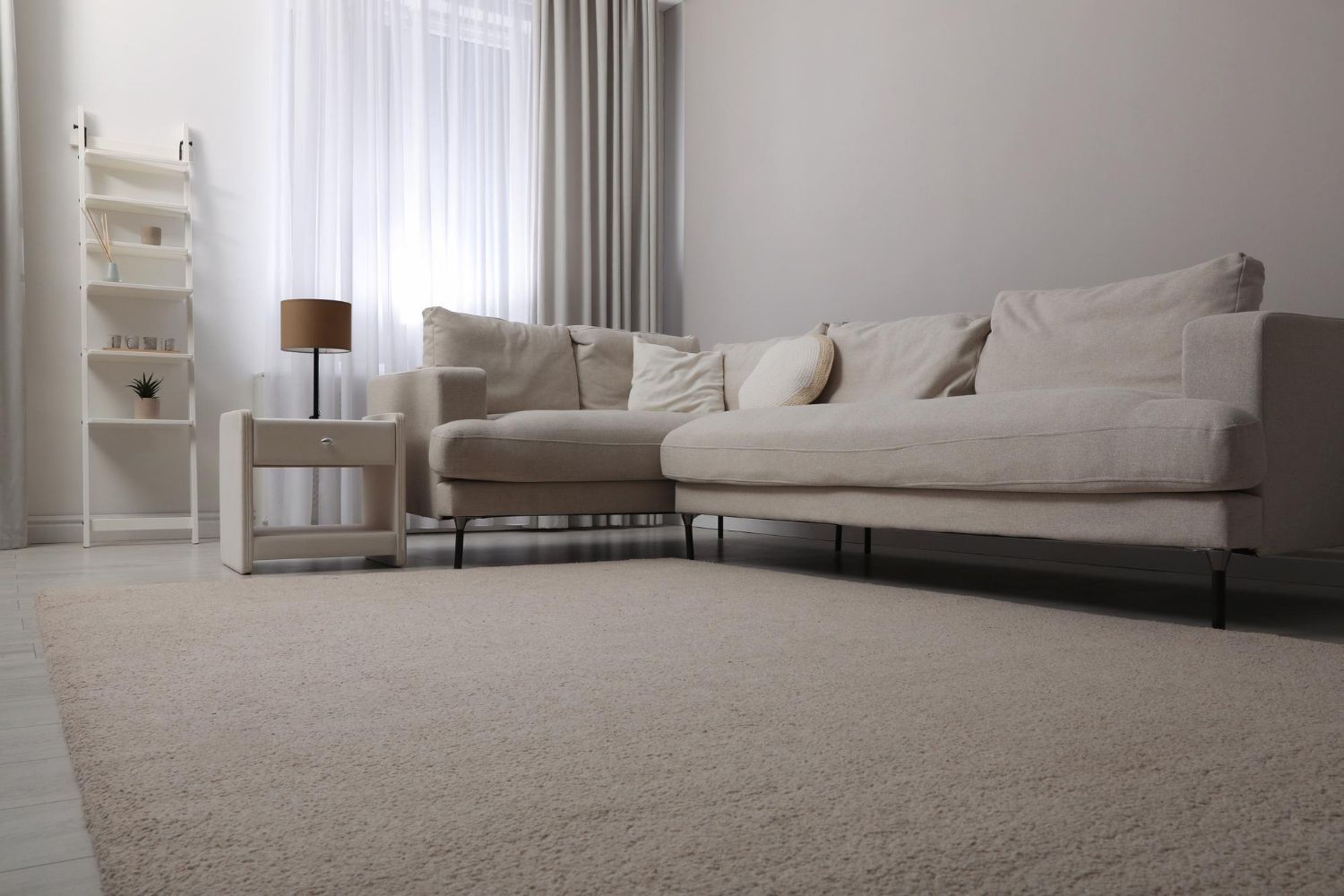 A living room with a couch , chair , table and rug.